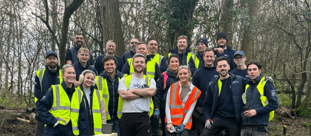 presence and co team dressed uin PPE working on landscaping for a local charity