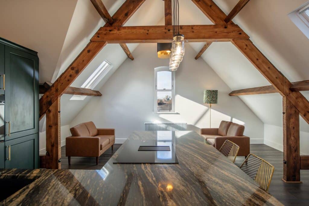 exposed beams in a converted buiding, showing warm lighting, a modern renovation and cosy interior. a development based in York