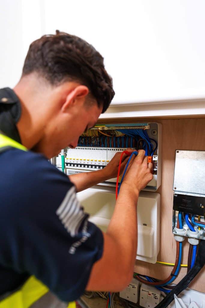 Electrician fixing sockets